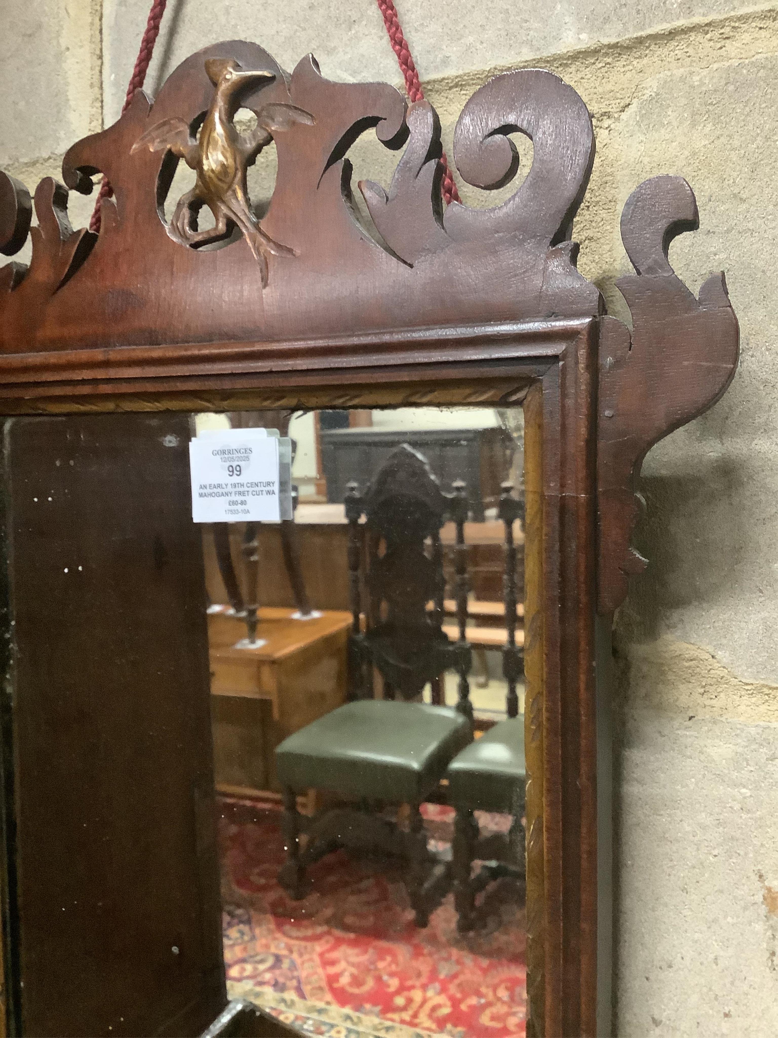 An early 19th century mahogany fret cut wall mirror, width 38cm, height 64cm. Condition - fair